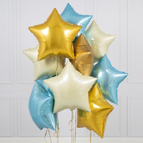 Bouquet of gold, white, and pale blue mylar star balloons