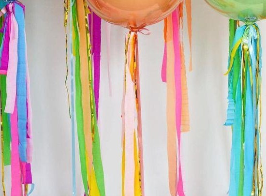 Example balloon tassels shown in green, pink, blue and gold